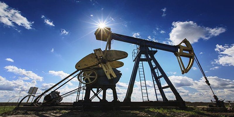 Oil pump jack against a blue sky